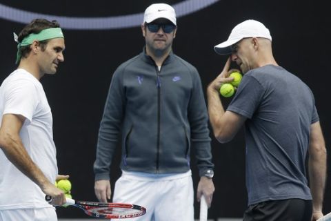 Switzerland's Roger Federer, left, talks with his coaches Ivan Ljubicic right, and Severin Luthi during a practice session ahead of the Australian Open tennis championships in Melbourne, Australia, Friday, Jan. 15, 2016.(AP Photo/Mark Baker)