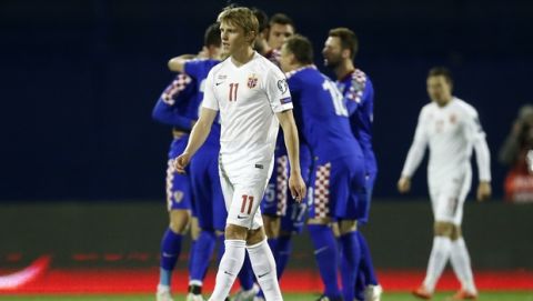 Norway's Martin Odegaard, center, looks on as Croatia players celebrate their second goal during the Euro 2016 Group H qualifying soccer match between Croatia and Norway at Maksimir Stadium in Zagreb, Croatia, Saturday, March 28, 2015. (AP Photo/Darko Bandic)