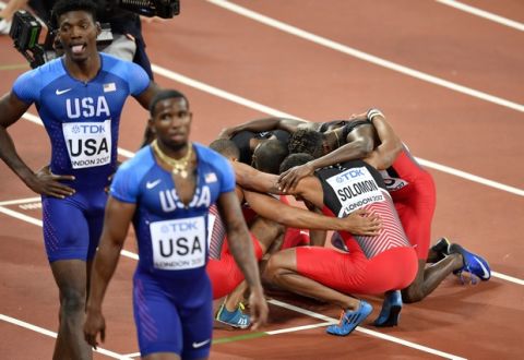 Trinidad and Tobago team members embrace after they won the gold medal in the Men's 4x400 meters relay final at the World Athletics Championships in London Sunday, Aug. 13, 2017. (AP Photo/Martin Meissner)