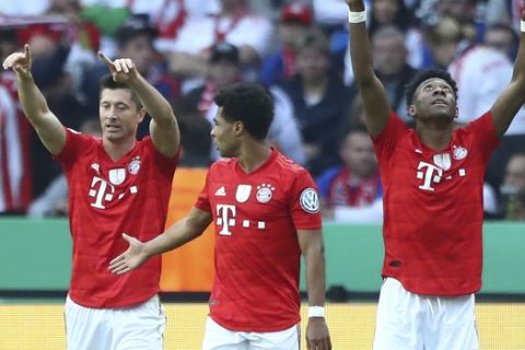 Bayern's Robert Lewandowski, left, celebrates his goal against RB Leipzig with his teammates Serge Gnabry, center, and David Alaba during the German soccer cup, DFB Pokal, final match between RB Leipzig and Bayern Munich at the Olympic stadium in Berlin, Germany, Saturday, May 25, 2019. (AP Photo/Matthias Schrader)