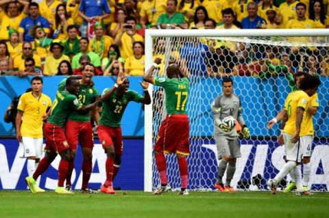 BRASILIA, BRAZIL - JUNE 23:  Joel Matip (3rd L) of Cameroon celebrates scoring his team's third goal with his teammates Vincent Aboubakar (2nd L), Allan Nyom (4th L) and Stephane Mbia (5th L) during the 2014 FIFA World Cup Brazil Group A match between Cameroon and Brazil at Estadio Nacional on June 23, 2014 in Brasilia, Brazil.  (Photo by Jeff Mitchell - FIFA/FIFA via Getty Images)