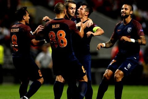 Istanbul's Emre Belozoglu, second right, celebrates with teammates after scoring his side's first goal during the Europa League group C soccer match between Sporting Braga and Istanbul Basaksehir at the Municipal stadium in Braga, Portugal, Thursday Sept. 28, 2017. (AP Photo/Paulo Duarte)
