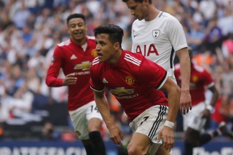 Manchester United's Alexis Sanchez celebrates after scoring his sides 1st goal of the game during the English FA Cup semifinal soccer match between Manchester United and Tottenham Hotspur at Wembley stadium in London, Saturday, April 21, 2018. (AP Photo/Frank Augstein)