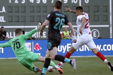 Liverpool goalie Andy Longergan (75) dives to make a save as Sevilla's Ocampos Lucas Ariel (25) tries to score past him and Liverpool's Andy Robertson (26) during the first half of a friendly soccer match at Fenway Park, Sunday, July 21, 2019, in Boston. (AP Photo/Mary Schwalm)