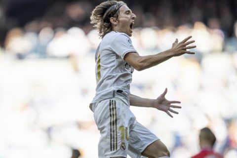 Real Madrid's Luka Modric celebrates after scoring during the Spanish La Liga soccer match between Real Madrid and Granada at the Santiago Bernarbeu stadium in Madrid, Saturday, Oct. 5, 2019. (AP Photo/Bernat Armangue)