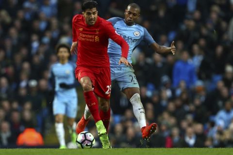 Liverpool's Emre Can vies for the ball with Manchester City's Fernandinho, right, during the English Premier League soccer match between Manchester City and Liverpool at the Etihad Stadium in Manchester, England, Sunday March 19, 2017. (AP Photo/Dave Thompson)