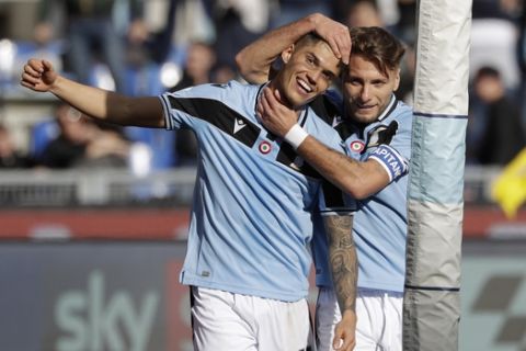Lazio's Joaquin Correa, left, celebrates with his teammate Ciro Immobile after scoring his side's second goal during an Italian Serie A Soccer match between Lazio and Bologna at Rome's Olympic stadium, Saturday, Feb. 29, 2020. (AP Photo/Andrew Medichini)