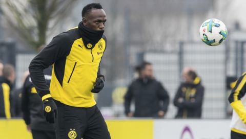 Jamaica's former sprinter Usain Bolt takes part in a practice session of the Borussia Dortmund soccer squad in Dortmund, Germany, Friday, March 23, 2018. (Guido Kirchner/dpa via AP)