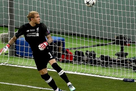 FILE - In this Saturday, May 26, 2018 file photo Liverpool goalkeeper Loris Karius looks at the ball after a fumble allowed Real Madrid's Gareth Bale to score his side's 3rd goal during the Champions League Final soccer match between Real Madrid and Liverpool at the Olimpiyskiy Stadium in Kiev, Ukraine. Doctors based in Boston have concluded Karius sustained a concussion during last month's Champions League final that would have affected his performance. (AP Photo/Darko Vojinovic, File)