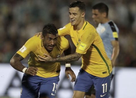 Brazil's Paulinho, left, is congratulated by teammate Brazil's P. Coutinho, after he scored against Uruguay during a 2018 World Cup qualifying soccer match in Montevideo, Uruguay, Thursday, March. 23, 2017. (AP Photo/Natacha Pisarenko)