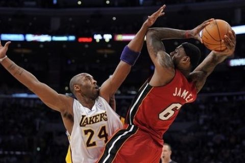 Los Angeles Lakers guard Kobe Bryant, left, fouls Miami Heat forward LeBron James during the first half of their NBA basketball game, Saturday, Dec. 25, 2010, in Los Angeles. (AP Photo/Mark J. Terrill)