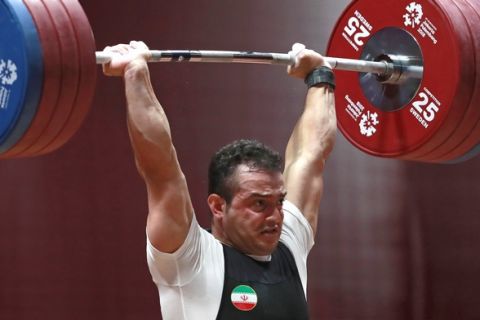 Iran's Sohrab Moradi competes during the men's 94kg weightlifting at the Asian Games in Jakarta, Indonesia, Saturday, Aug. 25, 2018. (AP Photo/Tatan Syuflana)