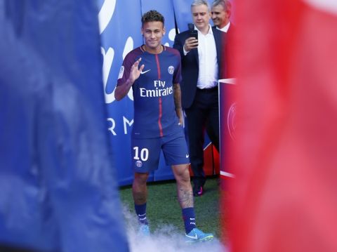 Brazilian soccer star Neymar arrives at the Parc des Princes stadium in Paris, Saturday, Aug. 5, 2017, during his official presentation to fans ahead of Paris Saint-Germain's season opening match against Amiens. Neymar would not play in the club's season opener as the French football league did not receive the player's international transfer certificate before Friday's night deadline. The Brazil star became the most expensive player in soccer history after completing his blockbuster transfer from Barcelona for 222 million euros ($262 million) on Thursday. (AP Photo/Francois Mori)