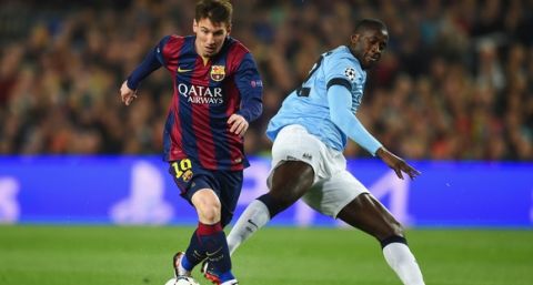 BARCELONA, SPAIN - MARCH 18: Lionel Messi of Barcelona is challenged by Yaya Toure of Manchester City during the UEFA Champions League Round of 16 second leg match between Barcelona and Manchester City at Camp Nou on March 18, 2015 in Barcelona, Spain.  (Photo by Michael Regan/Getty Images)