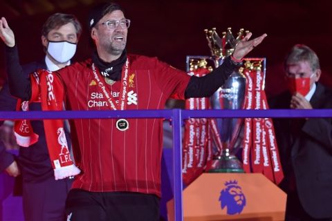 Liverpool's manager Jurgen Klopp celebrates after getting his winners medal following the English Premier League soccer match between Liverpool and Chelsea at Anfield Stadium in Liverpool, England, Wednesday, July 22, 2020. Liverpool are champions of the EPL for the season 2019-2020. The trophy is presented at the teams last home game of the season. Liverpool won the match against Chelsea 5-3. (Laurence Griffiths, Pool via AP)