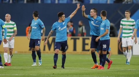 Zenit's Daler Kuzyayev, third right, celebrates scoring his side's second goal during the Europa League round of 32 second leg soccer match between Zenit St. Petersburg and Celtic at the Saint Petersburg stadium, in St. Petersburg, Russia, Thursday, Feb. 22, 2018. (AP Photo/Pavel Golovkin)