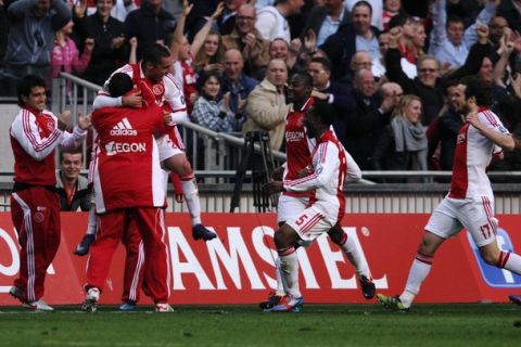 AMSTERDAM, NETHERLANDS - MARCH 25:  Ismail Aissati of Ajax celebrates with his team mates after scoring the first goal of the game during the Eredivisie match between Ajax Amsterdam and PSV Eindhoven at Amsterdam Arena on March 25, 2012 in Amsterdam, Netherlands.  (Photo by Dean Mouhtaropoulos/Getty Images)