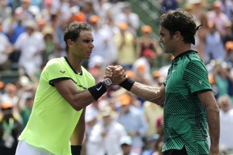 Rafael Nadal, of Spain, shakes hands with Roger Federer, of Switzerland, after the men's singles final at the Miami Open tennis tournament, Sunday, April 2, 2017, in Key Biscayne, Fla. Federer won 6-3, 6-4. (AP Photo/Lynne Sladky)