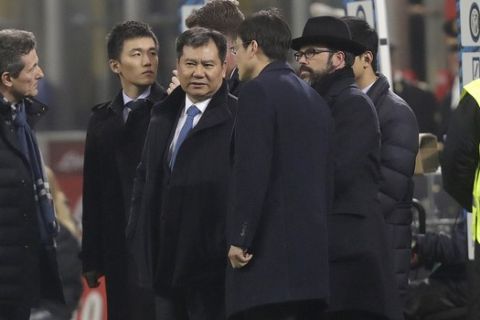 Suning Holdings Group chairman Zhang Jindong, third from left, waits for a Serie A soccer match between Inter Milan and Lazio, at the San Siro stadium in Milan, Italy, Wednesday, Dec. 21, 2016. (AP Photo/Luca Bruno)