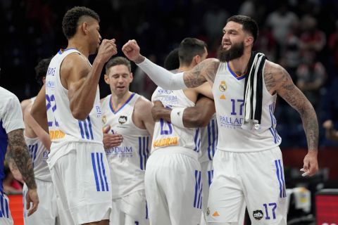 Real Madrid's Vincent Poirier, right, and his teammate Walter Tavares celebrate at the end of a Final Four Euroleague semifinal basketball match between Barcelona and Real Madrid, in Belgrade, Serbia, Thursday, May 19, 2022. (AP Photo/Darko Vojinovic)