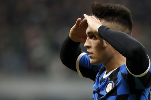 Inter Milan's Lautaro Martinez reacts after missing a chance to score during the Champions League group F soccer match between Inter Milan and Barcelona at the San Siro stadium in Milan, Italy, Tuesday, Dec. 10, 2019. (AP Photo/Antonio Calanni)