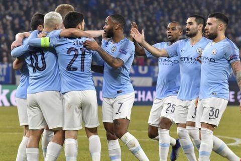 Manchester City forward Sergio Aguero, left, celebrates with his teammates after scoring his side's opening goal during the first leg, round of sixteen, Champions League soccer match between Schalke 04 and Manchester City at Veltins Arena in Gelsenkirchen, Germany, Wednesday Feb. 20, 2019. (AP Photo/Martin Meissner)