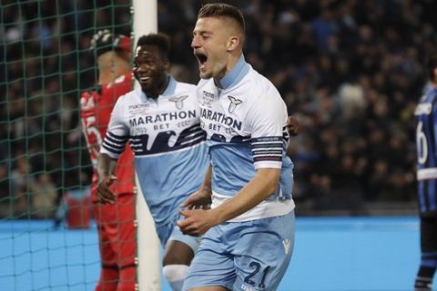 Lazio's Sergej Milinkovic Savic, right, celebrates after scoring his side's opening goal during the Italian Cup soccer final match between Lazio and Atalanta, at the Rome Olympic stadium, Wednesday, May 15, 2019. (AP Photo/Alessandra Tarantino)