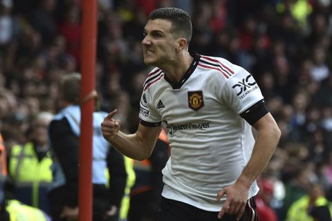 Manchester United's Diogo Dalot celebrates after scoring his side's opening goal during the English Premier League soccer match between Nottingham Forest and Manchester United at City ground in Nottingham, England, Sunday, April 16, 2023. (AP Photo/Rui Vieira)