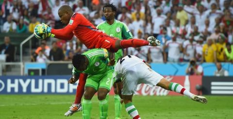 CURITIBA, BRAZIL - JUNE 16: Vincent Enyeama of Nigeria makes a save over teammates Joseph Yobo and Ashkan Dejagah of Iran during the 2014 FIFA World Cup Brazil Group F match between Iran and Nigeria at Arena da Baixada on June 16, 2014 in Curitiba, Brazil.  (Photo by Matthias Hangst/Getty Images)