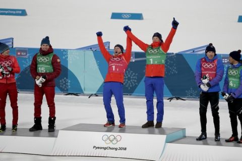 Gold medal winners Martin Johnsrud Sundby, of Norway and Johannes Hoesflot Klaebo, are flanked by silver medal winners Denis Spitsov, of the team from Russia, and Alexander Bolshunov, left, and bronze medal winners Richard Jouve, of France, and Maurice Manificat after the men's team sprint freestyle cross-country skiing final at the 2018 Winter Olympics in Pyeongchang, South Korea, Wednesday, Feb. 21, 2018. (AP Photo/Dmitri Lovetsky)