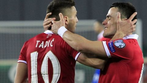Serbia's Dusan Tadic, center, and Filip Kostic celebrate their goal during the 2018 World Cup qualifying Group D soccer match between Georgia and Serbia at the Boris Paichadze Dinamo Arena in Tbilisi, Georgia, Friday, March 24, 2017. (AP Photo/Shakh Aivazov)