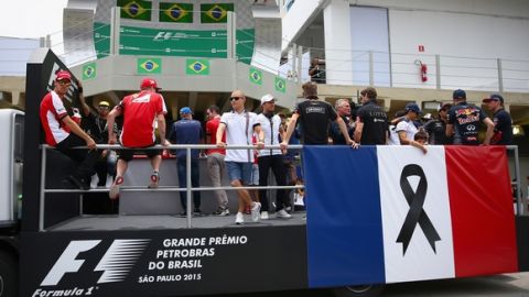 SAO PAULO, BRAZIL - NOVEMBER 15:  The drivers are seen during drivers' parade with the french flag to honor the victims of the terrorist attacks in Paris prior to the Formula One Grand Prix of Brazil at Autodromo Jose Carlos Pace on November 15, 2015 in Sao Paulo, Brazil.  (Photo by Clive Mason/Getty Images)