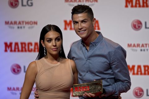 Juventus soccer player Cristiano Ronaldo poses with his partner, model Georgina Rodriguez after receiving the Lifetime Achievement award given by the Spanish sports paper 'Marca', in Madrid, Spain, Monday, July 29, 2019. (AP Photo/Paul White)