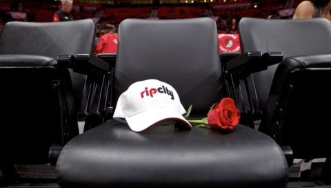 The seat for Trail Blazers owner Paul Allen, who passed away on Oct. 15, has a rose and a hat placed on it before an NBA basketball game in Portland, Ore., Thursday, Oct. 18, 2018. (AP Photo/Craig Mitchelldyer)