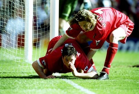 3 Apr 1999:  Robbie Fowler of Liverpool is pulled away by team mate Steve McManaman after mimicking cocaine snorting to celebrate his first goal against Everton in the FA Carling Premiership match at Anfield in Liverpool, England. Liverpool won 3-2. \ Mandatory Credit: Ross Kinnaird /Allsport