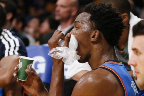 Oklahoma City Thunder center Hasheem Thabeet holds ice to his face against the Los Angeles Lakers during the first half of an NBA basketball game in Los Angeles, Sunday, March 9, 2014. (AP Photo/Danny Moloshok)
