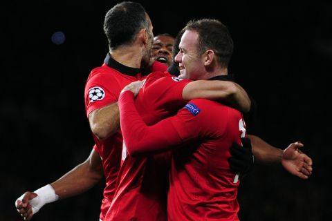 Manchester United's Welsh midfielder Ryan Giggs (L), French defender Patrice Evra (2nd L), Mexican striker Javier Hernandez (2nd R) and English striker Wayne Rooney (R) celebrate after Real Sociedad's defender Inigo Martinez scores an own goal during the UEFA Champions League Group A football match between Manchester United and Real Sociedad at Old Trafford in Manchester, northwest England on October 23, 2013. AFP PHOTO/ANDREW YATES        (Photo credit should read ANDREW YATES/AFP/Getty Images)