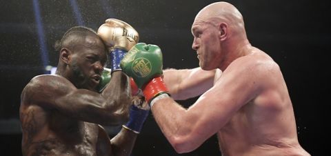 FILE - In this Dec. 1, 2018, file photo, Tyson Fury, right, of England, connects with Deontay Wilder during a WBC heavyweight championship boxing match in Los Angeles. Wilder is still frustrated by the way he fought in his draw with Fury. The WBC heavyweight champion watched a replay of the fight for the first time Thursday, Dec. 6, 2018, and saw things he did incorrectly. (AP Photo/Mark J. Terrill, File)