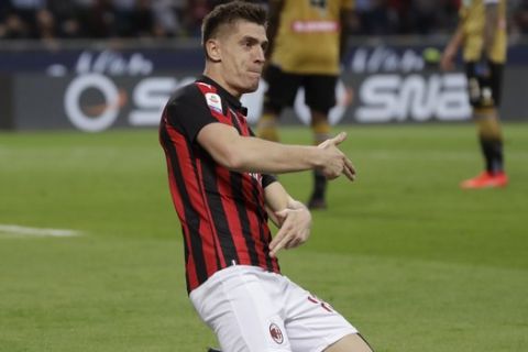 AC Milan's Krzysztof Piatek celebrates after scoring his side's opening goal during the Serie A soccer match between AC Milan and Udinese, at the San Siro stadium in Milan, Italy, Tuesday, April 2, 2019. (AP Photo/Luca Bruno)