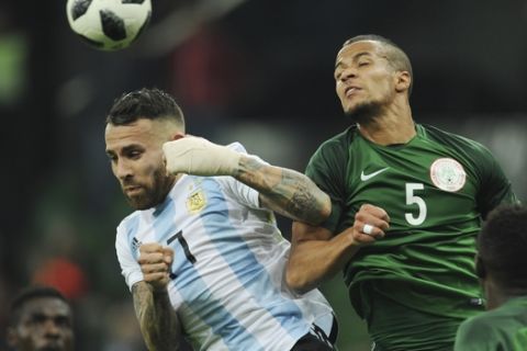 Argentina's Nicolas Otamendi, left, challenges for the ball with Nigeria's William Troost-Ekong during the international friendly soccer match between Argentina and Nigeria in Krasnodar, Russia, Tuesday, Nov. 14, 2017. (AP Photo/Sergey Pivovarov)