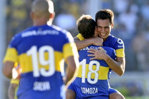 Boca Juniors' midfielder Juan Sanchez Mino (R) celebrates with teammates after scoring a goal against San Lorenzo,, during their Argentina First Division football match at the Nuevo Gasometro stadium in Buenos Aires, on March 4, 2012.  AFP PHOTO / Alejandro PAGNI (Photo credit should read ALEJANDRO PAGNI/AFP/Getty Images)