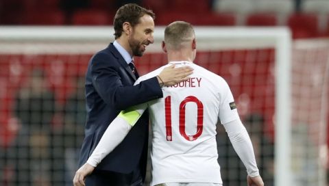 England's manager Gareth Southgate pats England's Wayne Rooney on the back after the international friendly soccer match between England and the United States, Rooney's 120th cap, at Wembley stadium, Thursday, Nov. 15, 2018. (AP Photo/Alastair Grant)