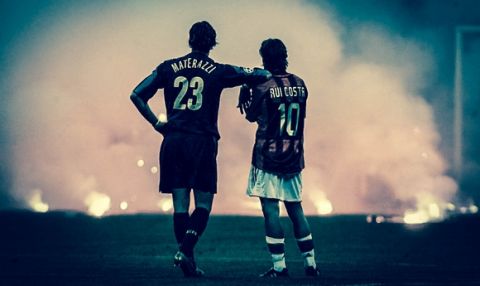 Inter Milan's Marco Materazzi  (L) and AC Milan's Manuel Rui Costa waits on the pitch as supporters throw flares onto the pitch during their Champions League quarter-final second leg soccer match at the San Siro Stadium in Milan April 12, 2005.                             REUTERS/Stefano Rellandini