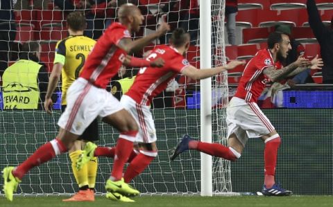 Benfica's Kostas Mitroglou, right, celebrates scoring the opening goal during the Champions League round of 16, first leg, soccer match between Benfica and Borussia Dortmund at the Luz stadium in Lisbon, Tuesday, Feb. 14, 2017. (AP Photo/Armando Franca)