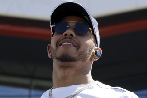 Mercedes driver Lewis Hamilton of Britain smiles during a drivers parade prior to the start of the British Formula One Grand Prix at the Silverstone racetrack, Silverstone, England, Sunday, July 8, 2018. (AP Photo/Luca Bruno)