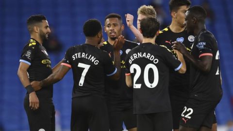 Manchester City's Raheem Sterling (7) celebrates after scoring his side's third goal during the English Premier League soccer match between Brighton and Manchester City at the Falmer stadium in Brighton, England, Saturday, July 11, 2020. (Julian Finney/Pool via AP)