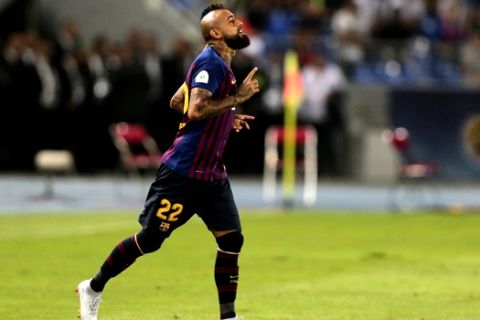 Barcelona's Arturo Vidal gestures during the Spanish Super Cup soccer match between Sevilla and Barcelona in Tangier, Morocco, Sunday, Aug. 12, 2018. (AP Photo/Mosa'ab Elshamy)