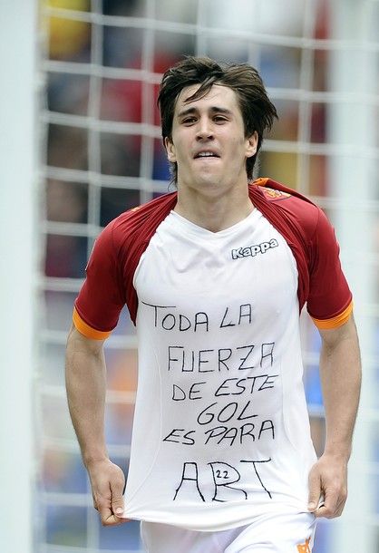 AS Roma's Spanish forward Bojan Krkic Perez shows his t-shirt reading "All the power of this goal is for Abi (Eric Abidal)" as he celebrates scoring against Novara during the Serie A football match in Rome's Olympic Stadium on April 1, 2012. Abidal, 32, had a tumour removed from his liver in March 2011. The announcement that he now has to have a transplant has seen an outpouring of support from the world of football.     AFP PHOTO / Filippo MONTEFORTE (Photo credit should read FILIPPO MONTEFORTE/AFP/Getty Images)