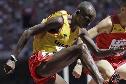 FILE - Uganda's Benjamin Kiplagat, front, competes in round one of the men's 3000m steeplechase during the World Athletic Championships at the Bird's Nest stadium in Beijing, Saturday, Aug. 22, 2015. Police in Kenya say they are investigating the slaying of three-time Ugandan Olympian Benjamin Kiplagat. A local police official says Kiplagat's body was found with stab wounds inside his brothers car on Sunday morning. (AP Photo/David J. Phillip), File)