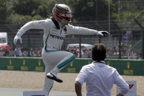 Mercedes driver Lewis Hamilton of Britain celebrates after getting the pole position in the qualifying session for the British Formula One Grand Prix, at the Silverstone racetrack, Silverstone, England, Saturday, July 7, 2018. The British Formula One Grand Prix will be held on Sunday. (AP Photo/Luca Bruno)